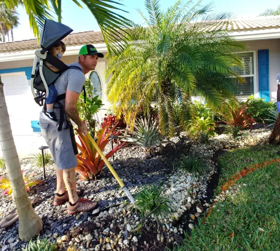 Rick, owner of Elegant Edgings Inc, installing custom concrete curb landscape edging on a residential yard